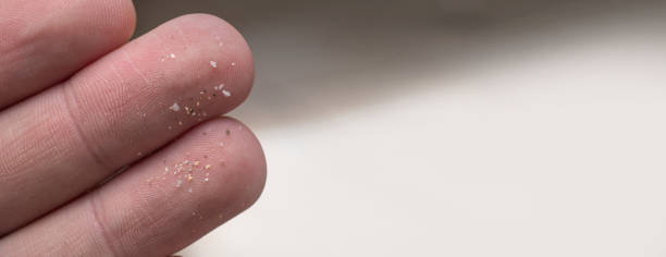 istock Micro plastic particles on a human finger for scale. Concept for water pollution and global warming. 1409308629