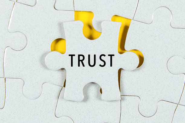 trust word on a jigsaw puzzle - trust stockfoto's en -beelden