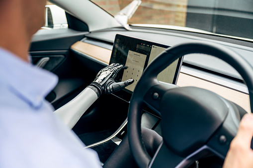 Bionic Arm Computer London Man With Bionic Arm Using Computer In Electric Car Stock Photo ...