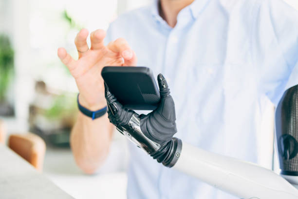istock Close-up of man with bionic arm using smart phone 1409312460