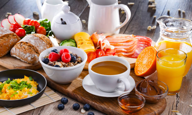 Breakfast served with coffee, scrambled eggs, cereals and ham Breakfast served with coffee, orange juice, scrambled eggs, cereals, ham and cheese. breakfast stock pictures, royalty-free photos & images