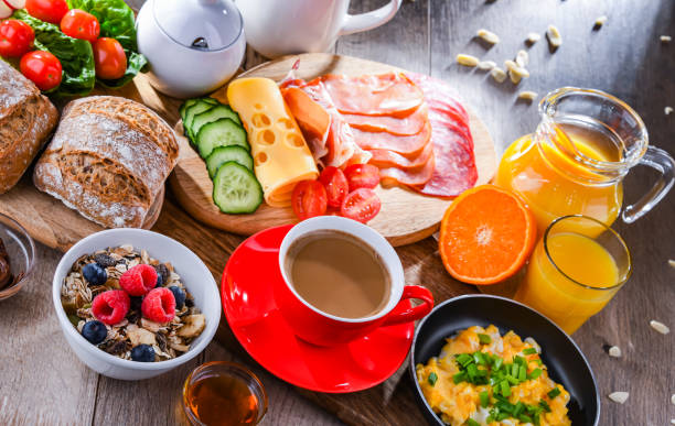 istock Breakfast served with coffee, scrambled eggs, cereals and ham 1409314730