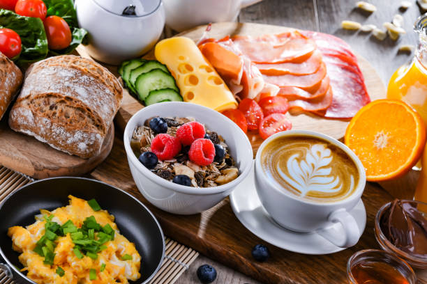 istock Breakfast served with coffee, scrambled eggs, cereals and ham 1409314872