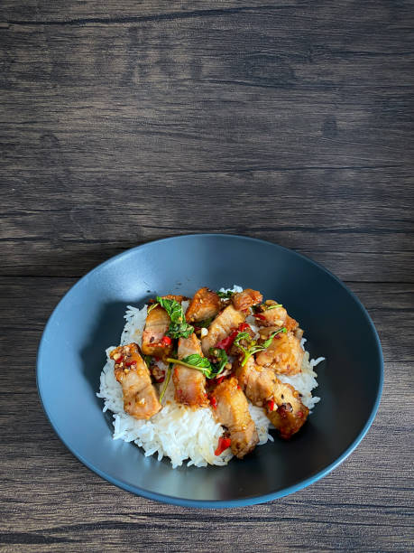 Rice topped with crispy pork belly with Thai basil