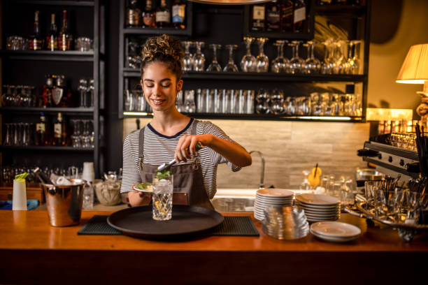 istock Young female bartender preparing an alcohol cocktail 1409317387