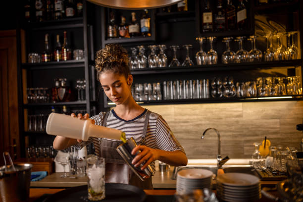 istock Young female bartender preparing an alcohol cocktail 1409317416