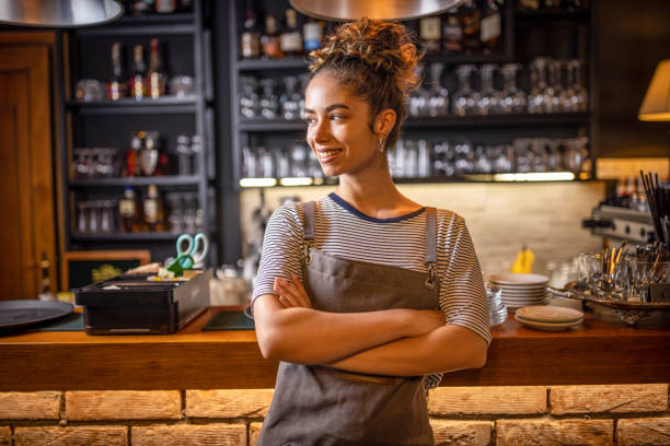 istock Proud waitress standing at counter 1409317532