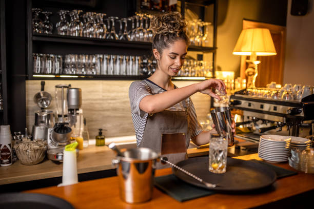istock Woman bartender making cocktails in a bar 1409317616