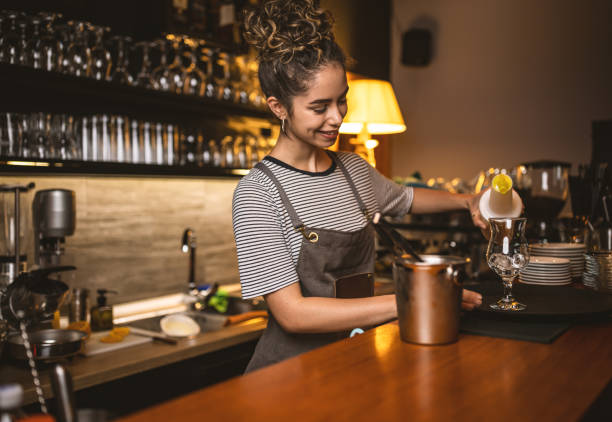 istock Woman bartender making cocktails in a bar 1409317860