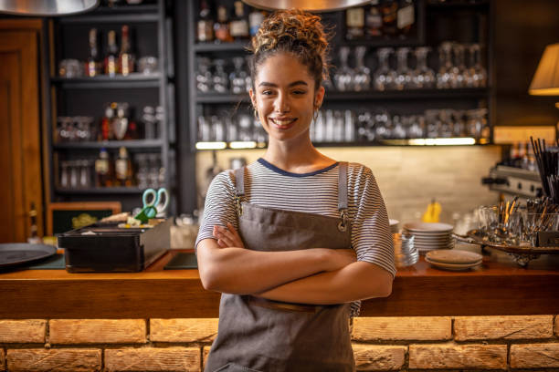 istock Proud waitress standing at counter 1409318875