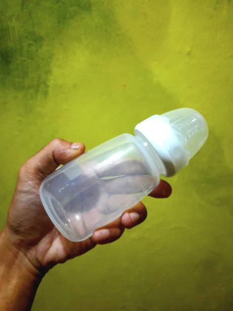 istock a person's hand holding a milk bottle 1409320123