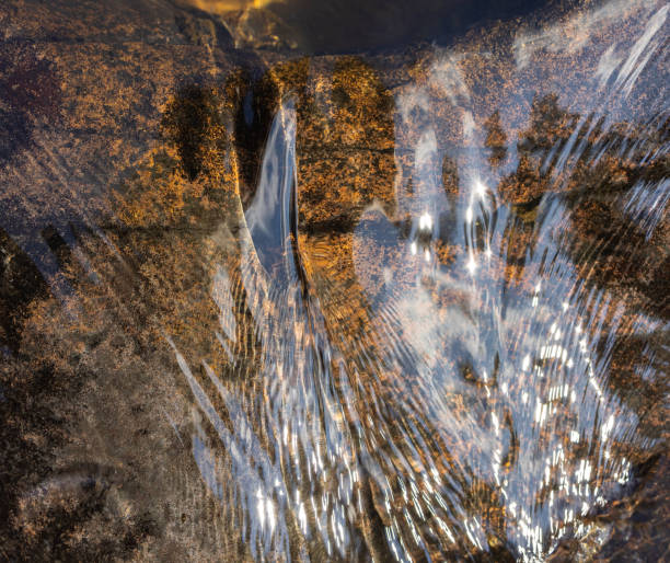istock Clear transparent water flowing in a mountain stream. 1409321174