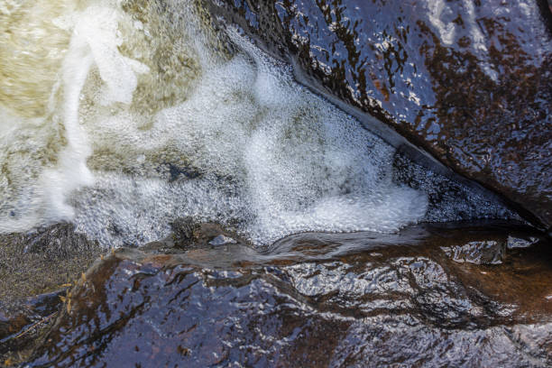 Looking down on the bubbling water stream around the rocks at Tobyhanna Falls, Poconos, Pennsylvania.