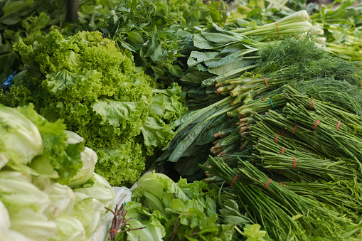 Several stacked green thai vegetables on local market