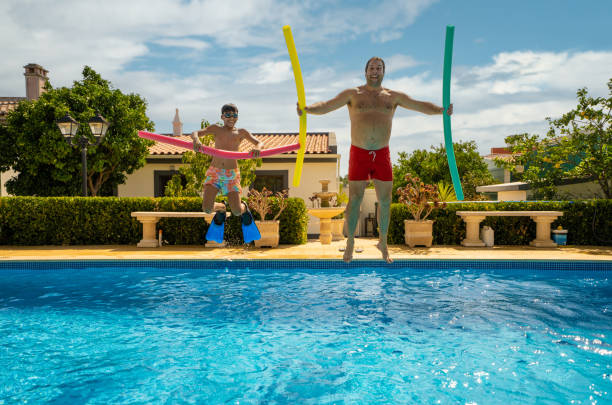family jumping in the pool - men latin american and hispanic ethnicity southern european descent mature adult imagens e fotografias de stock