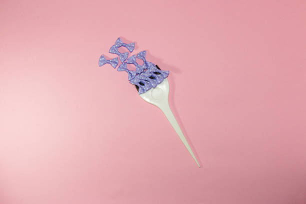 istock small white brush with purple bows on a pink background, creative art design, modern idea 1409329011