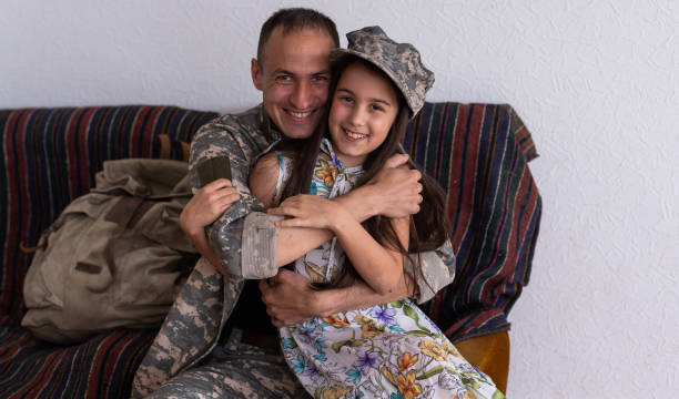 istock Affectionate military father with daughter at home. 1409329687