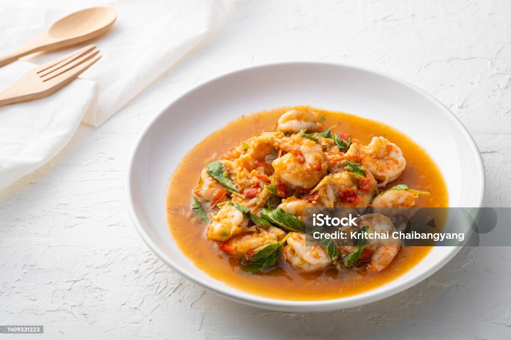 Stir fried shrimp with basil Stir fried shrimp with basil on white plate,thai spicy food Shrimp - Seafood Stock Photo