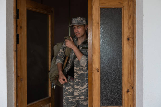istock White military man wearing uniform with backpack at home 1409332698