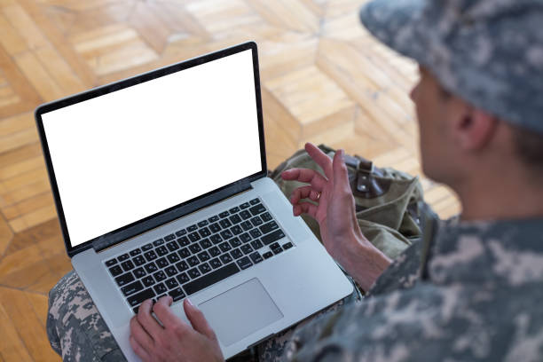istock soldier in military uniform using high tech computer in headquarters intelligence center 1409333362