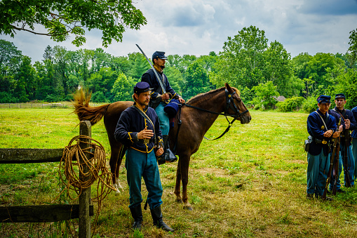 Lancaster, PA, USA  July 16, 2022: Union Armys Cavalry Soldiers explain their duties and tactics to visitors at the Landis Valley Farm Museum during the Civil War Weekend Event.