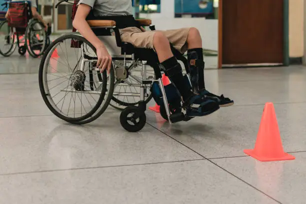 Photo of Special need child practicing wheelchair by an occupational therapist teacher