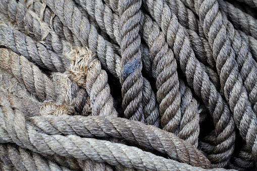 Tangled coarse linen ropes. Texture for the background. Selective focus