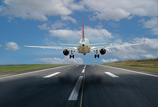 Passenger airplane landing at dusk