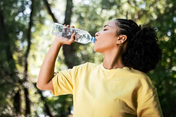 Young Woman Hydrating taking a break