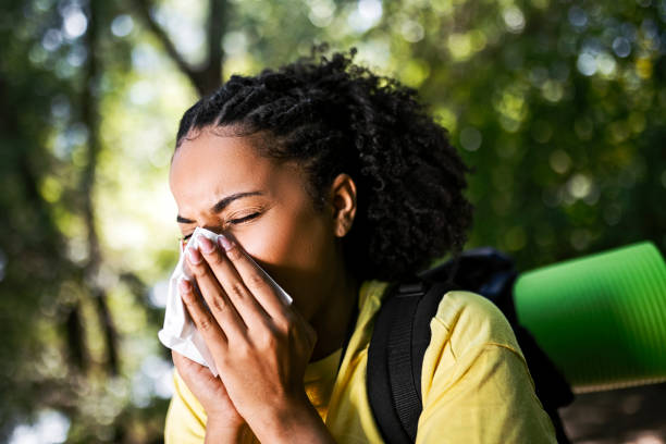 istock Young woman hiker having allergy sneezing using handkerchief 1409338640