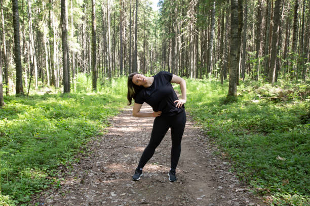 istock A fat woman runs around the park. 1409339362