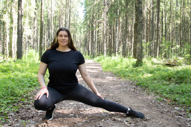 istock A fat woman runs around the park. 1409339407