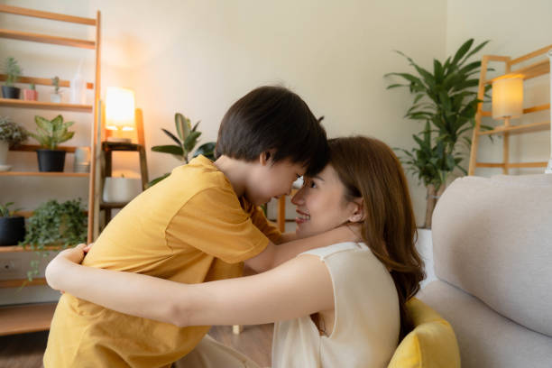 istock Playful mother having fun while stay at home with boy. 1409339447