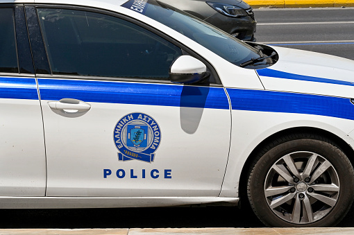 Athens, Greece - May 2022: Side view of the badge on a patrol car of the city's police force