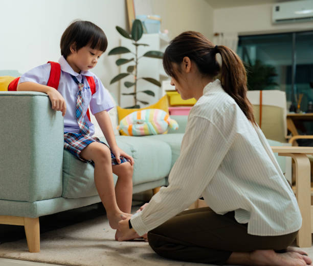 istock Mother helping preschool son get dressed and putting backpack before go to school. 1409340844