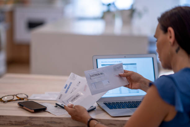 istock Woman Frustrated Paying Bills At Home 1409343791