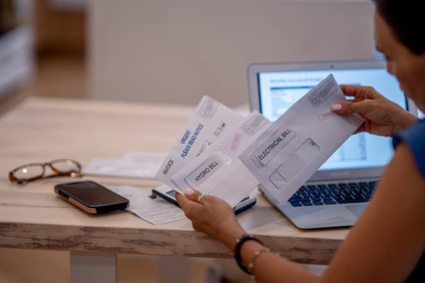 istock Woman Frustrated Paying Bills At Home 1409343819