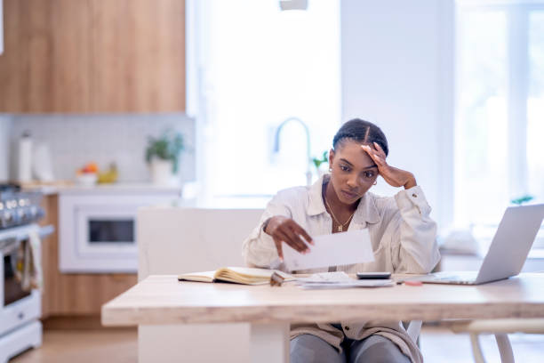 istock Woman Paying Bills At Home 1409344018