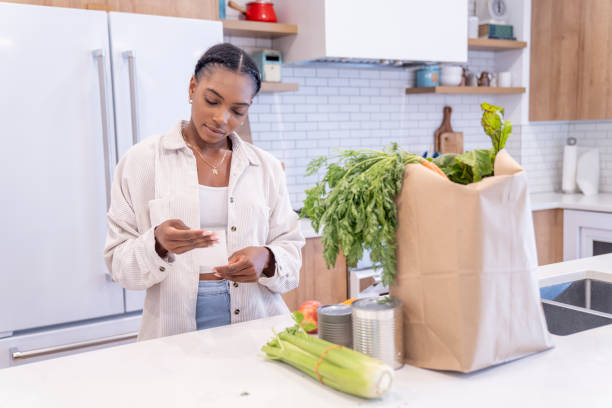 istock Woman Reviewing Grocery Bill 1409344159