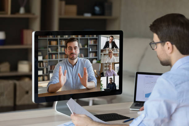 Young male take part in webcam business conference using pc