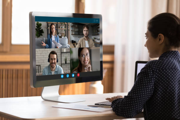 istock Indian female talk to diverse young people by group videocall 1409344317