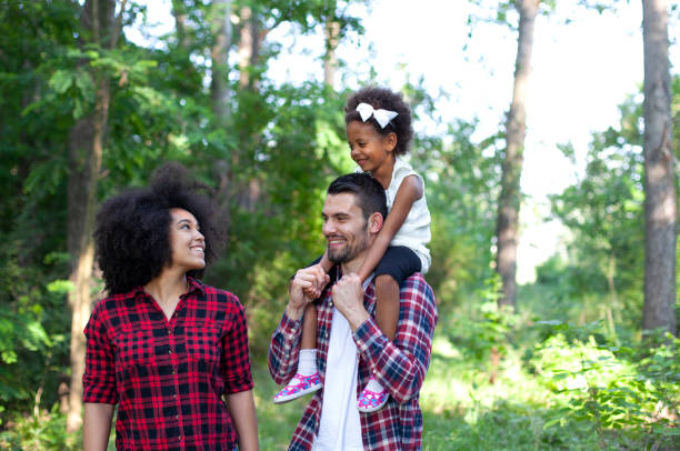 istock Happy family walking along a path in the woods 1409344500