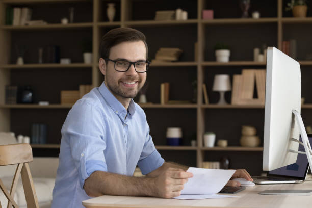 istock Business portrait smiling young manager sitting by computer at workplace 1409344647