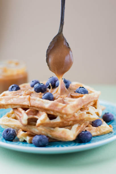 istock Belgian waffles and caramel sauce 1409344690