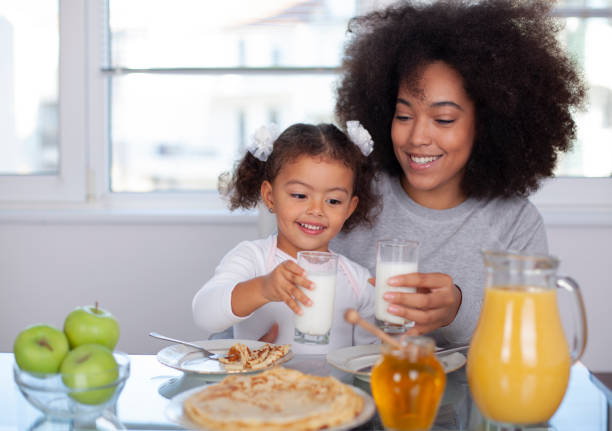 istock African-American young mother and daughter having breakfast 1409344718