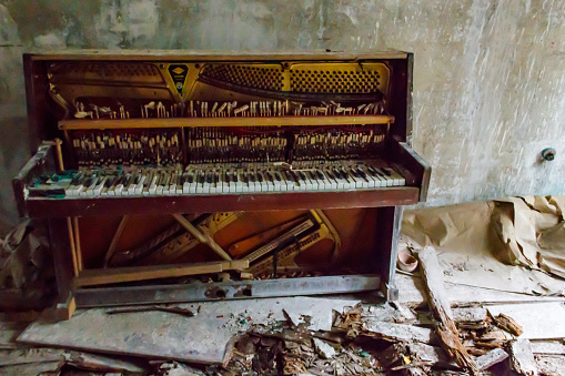 Old piano in abandoned apartment in the ghost town Pripyat in Chernobyl Exclusion Zone, Ukraine