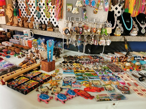 Crown Point, Tobago - June 14, 2022 - Souvenirs on display and for sale in huts or shops in Store Bay. Store Bay is one of the main tourist destinations on the Caribbean island of Tobago. These souvenirs were designed and made by local artists and craftsmen and craftswomen.