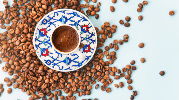 Turkish coffee pot of coffee beans with coffee cup aon linen table