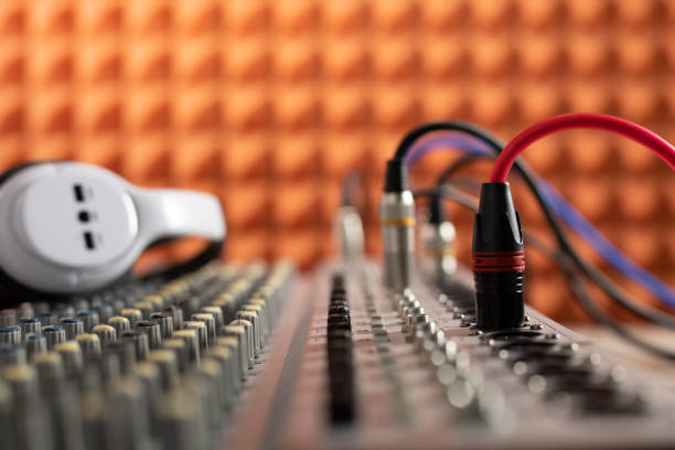 Auidio jack cable in sound mixer. Music concept in sound record studio Auidio jack cable and sound mixer. Music concept in sound record studio black orange audio stock pictures, royalty-free photos & images