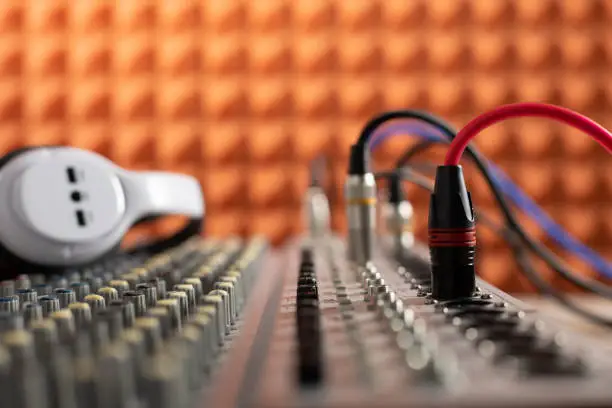 Photo of Auidio jack cable in sound mixer. Music concept in sound record studio